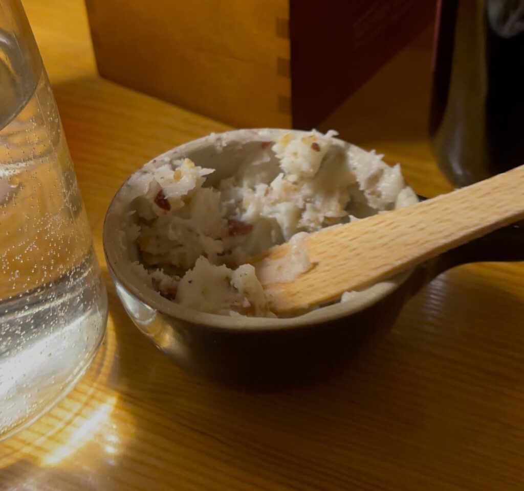 a bowl of smalec sitting on a table. smalec is a traditional lard spread.
