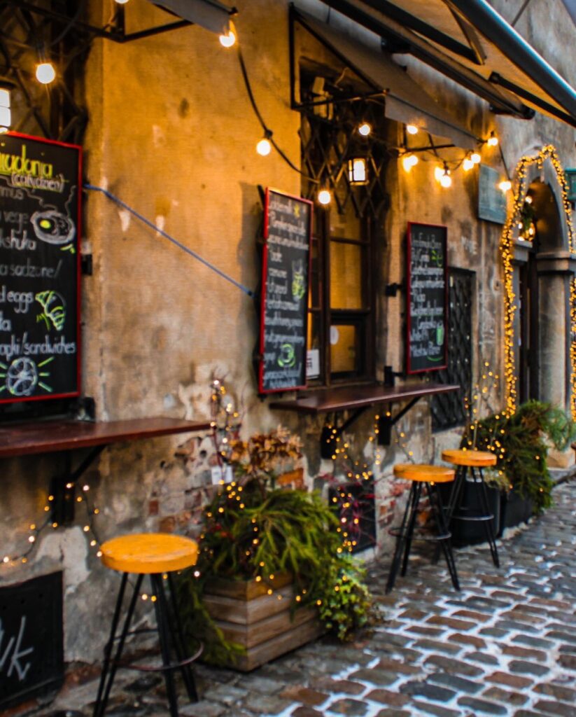 A Cafe front with chalkboard menus and eclectic vibes in Kazimierz Krakow Poland