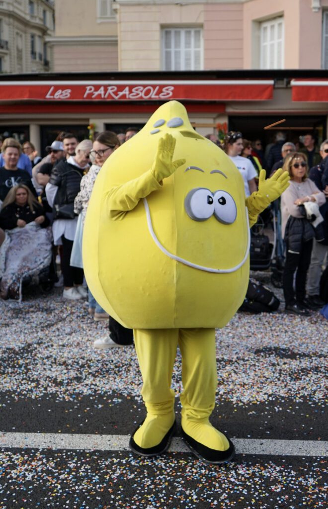 Menton Mascot, a human dressed as a lemon dancing in the street!