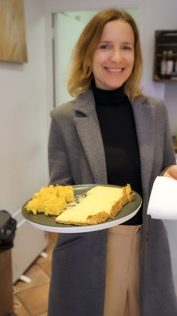 Patricia, Owner of Food Tour Riviera holding a plate of desserts.