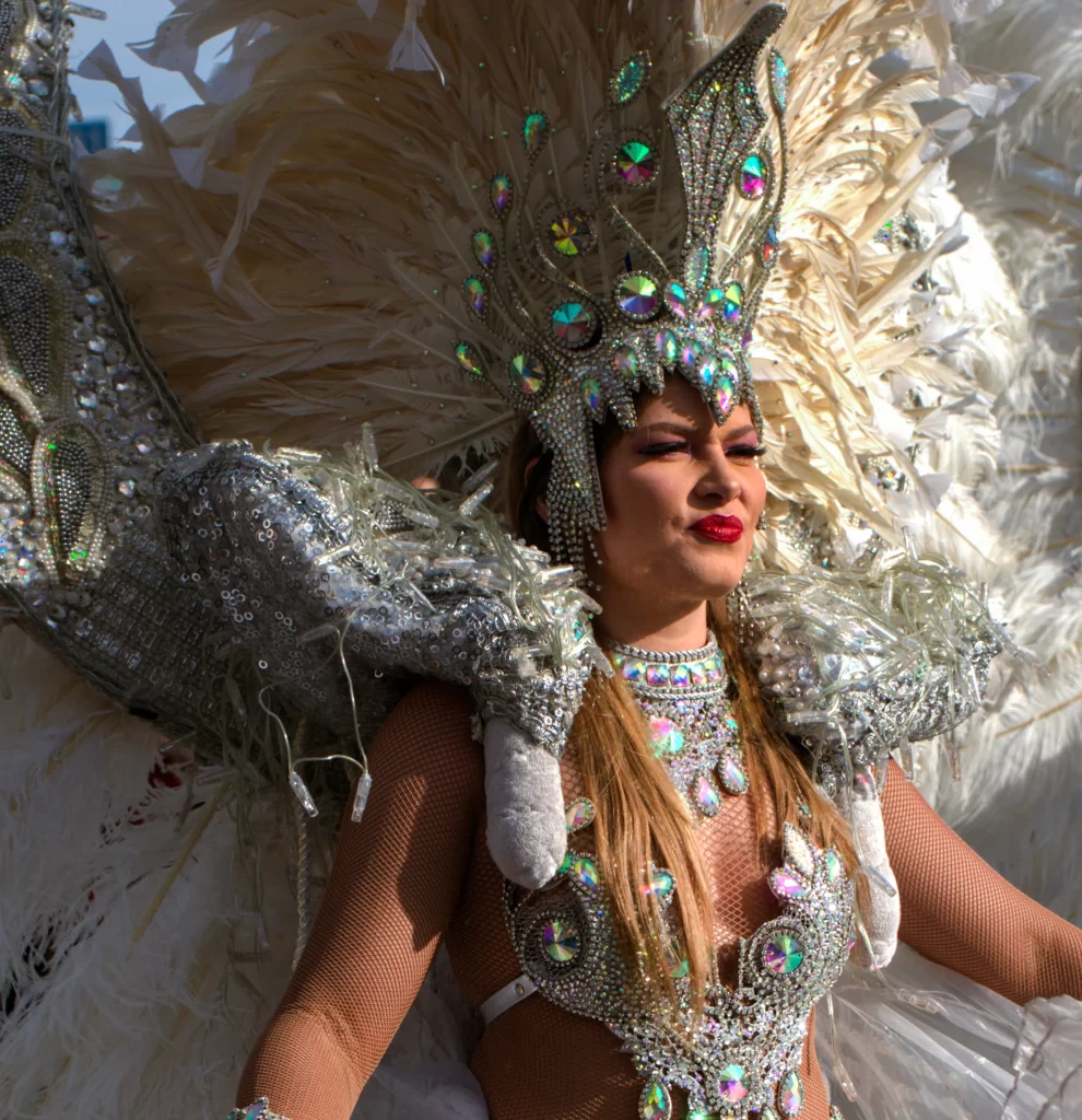 Woman in white and silver headdress with rinestones at the fete du citron