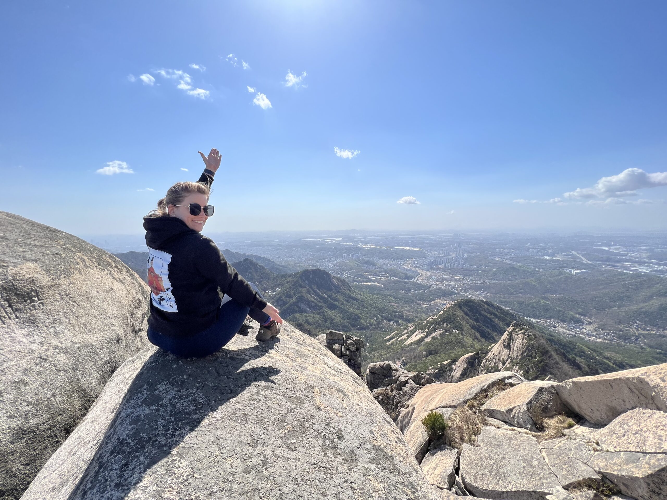 Woman with outstretched arms on a mountain in Korea