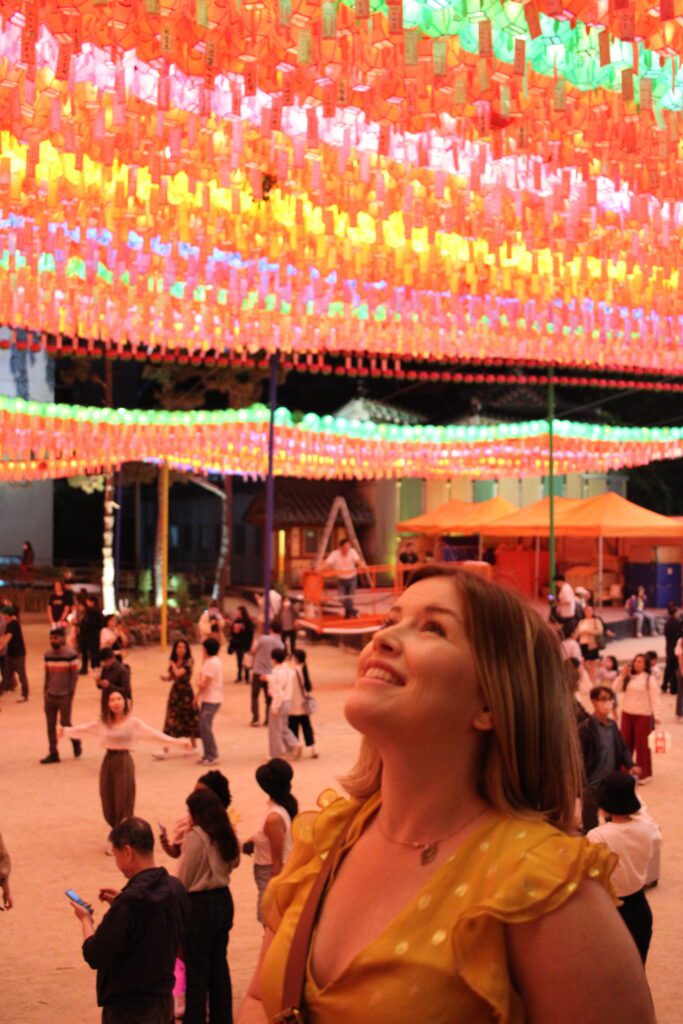 Woman looking up at colorful lanterns in Seoul Korea