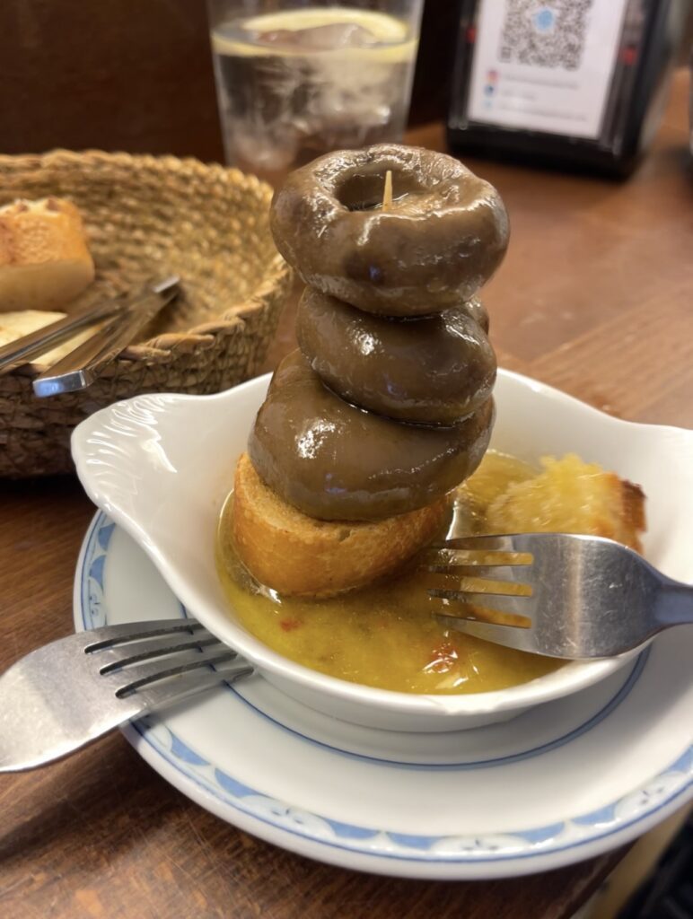 A Traditional Pintxos is pictured, Mushrooms stacked high on bread from famous Bar Martinez