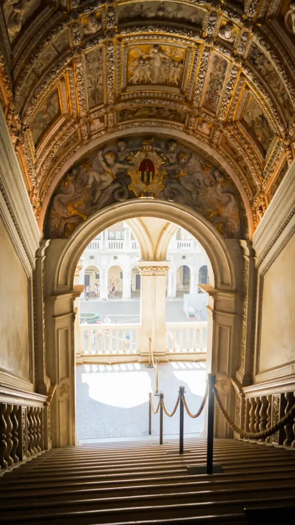 Inside the ornate doge palace and the hallways with colorful gold frescoes