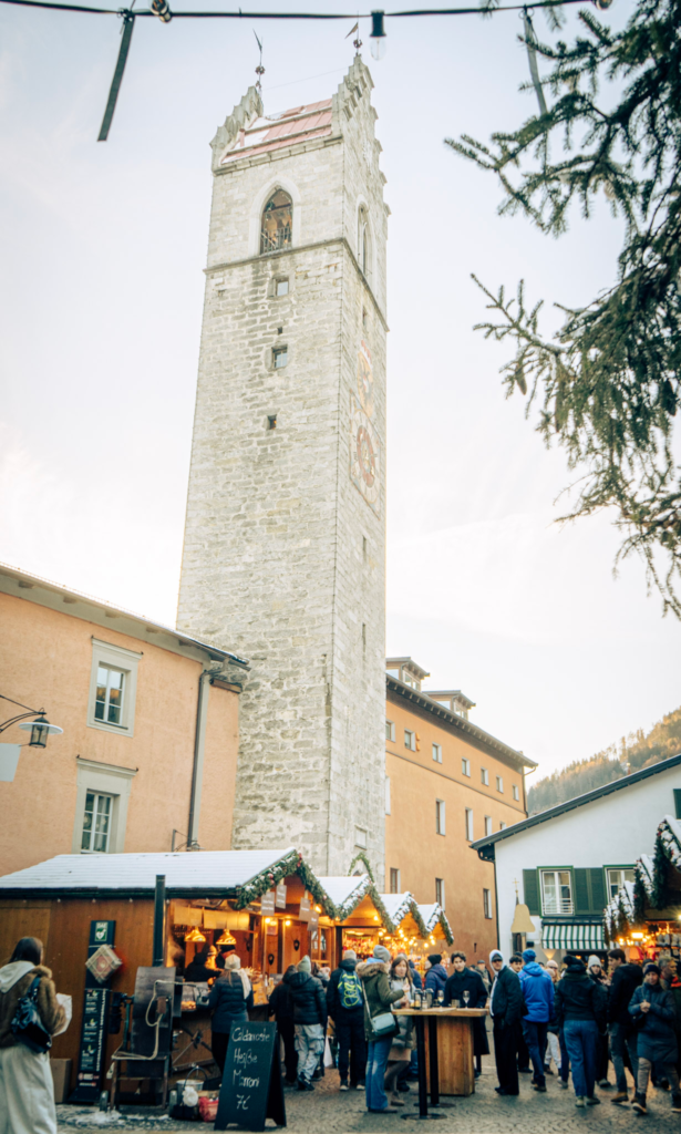 Sterzing (Vipiteno) Christmas Market with wooden stalls and Zwölferturm tower in South Tyrol, Italy