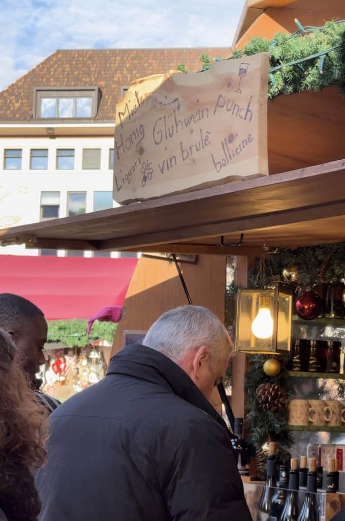 a man getting mulled wine at the bolzano Christmas market