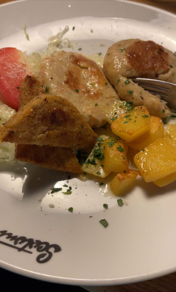 Cheese Dumplings and grilled potatos on a white plate 