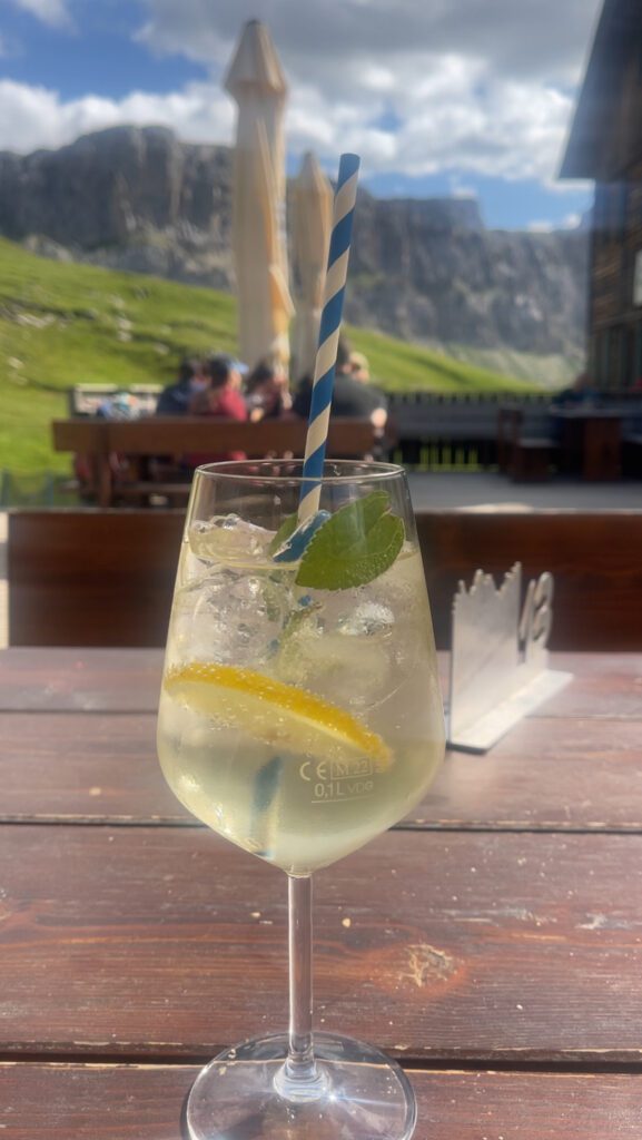 A Glass with a Hugo Spritz on a wooden table