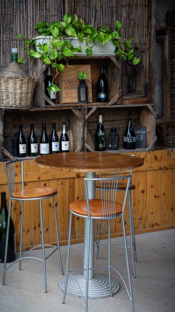 an empty table adorned with bottles at Casa Brunoro