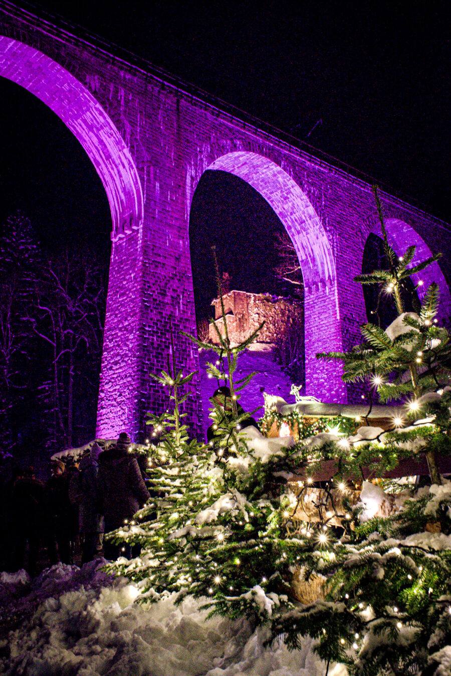 Ravenna Gorge Bridge Lit up with a Christmas tree below it.