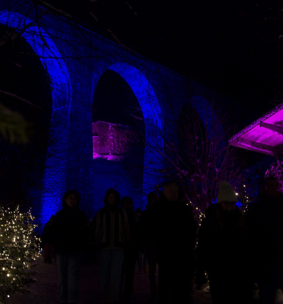 Outline of Ravenna Gorge in Blue with Christmas Lights in the back