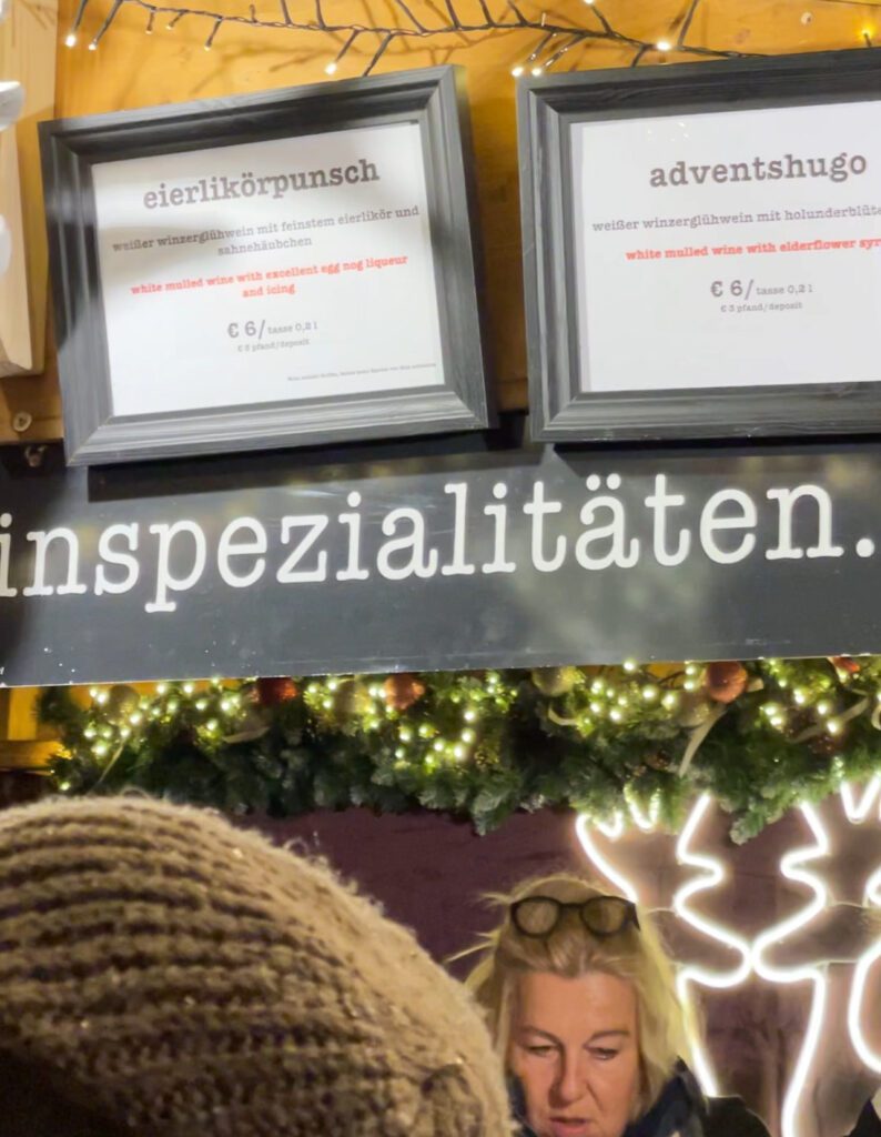 Signs for eggpunch and a christmas hugo at a christmas market stall in the Ravenna Gorge