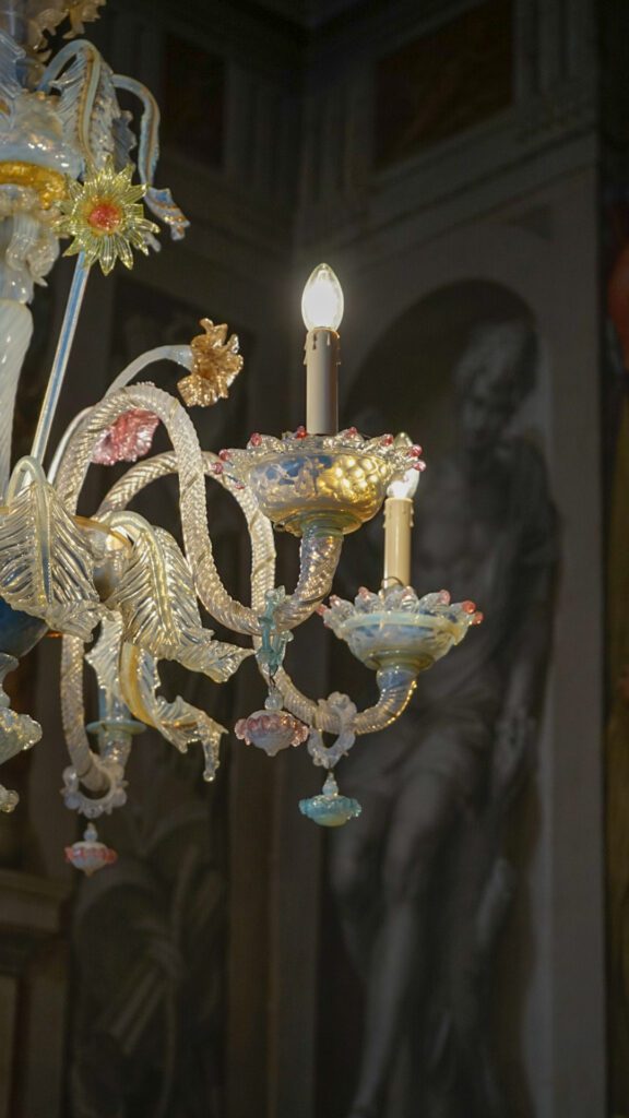 A decorative chandelier in Villa Godi Malinverni in Vicenza Italy. Colorful glass is illuminated by a light.