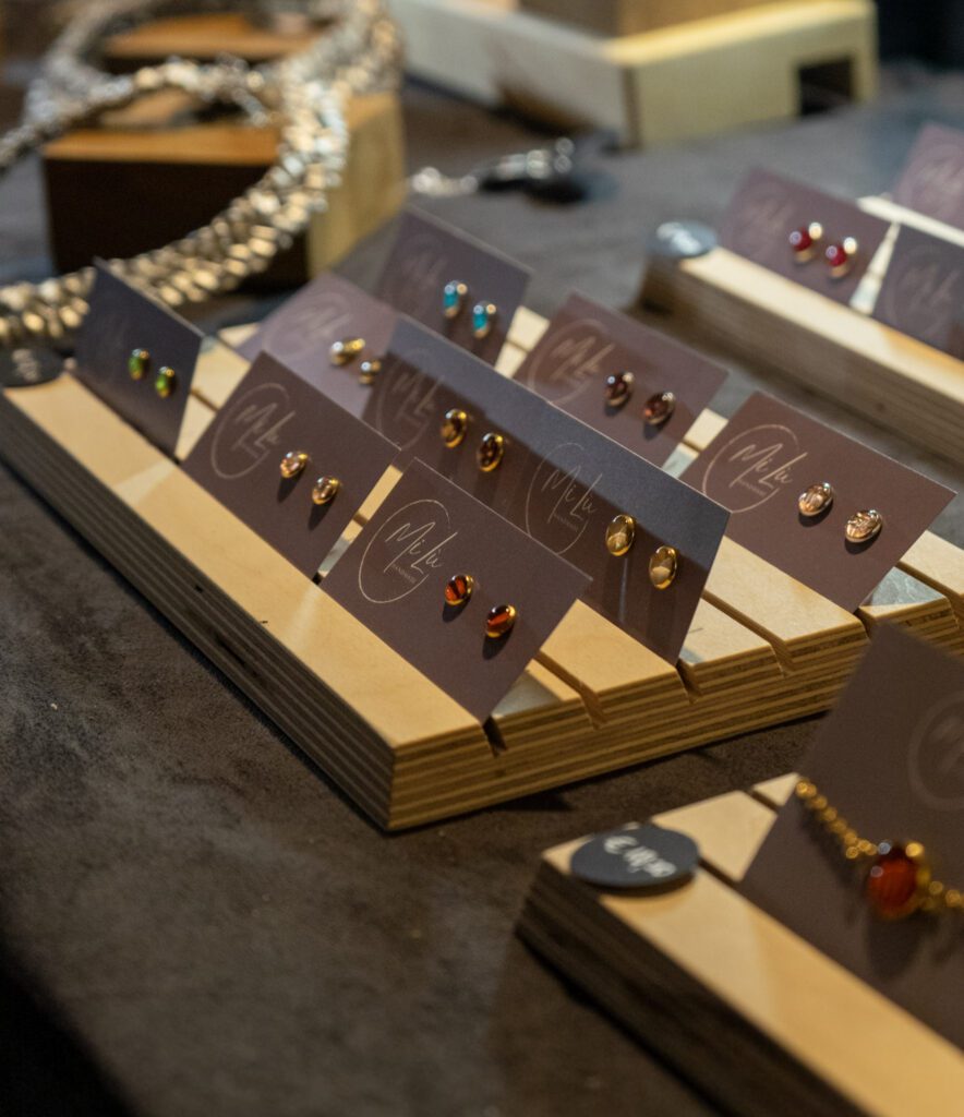 earrings made by a local vendor in Trentino. Colorful earrings laying on a wooden board