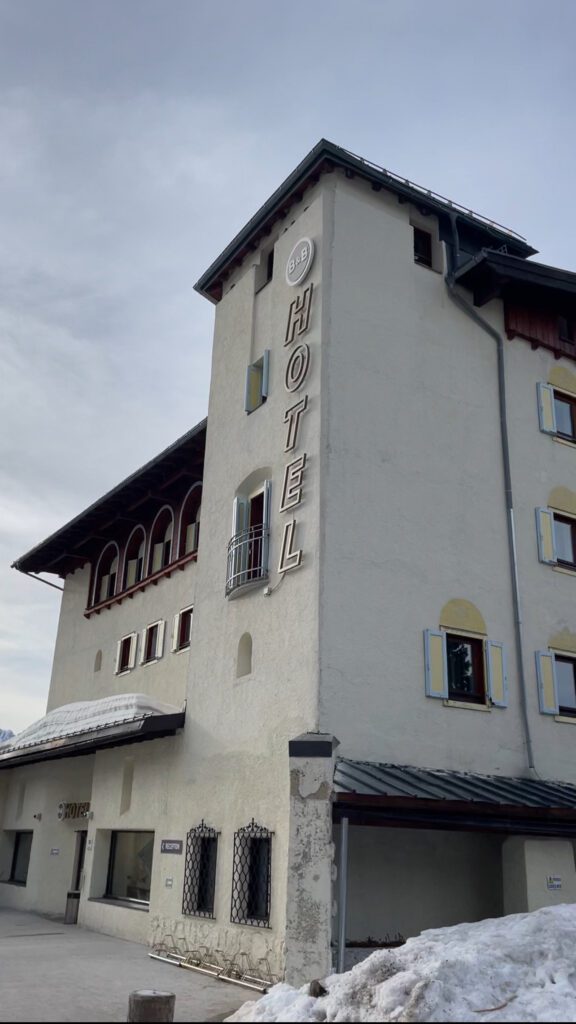 Facade of Tre Croci B&B with snow on the ground.