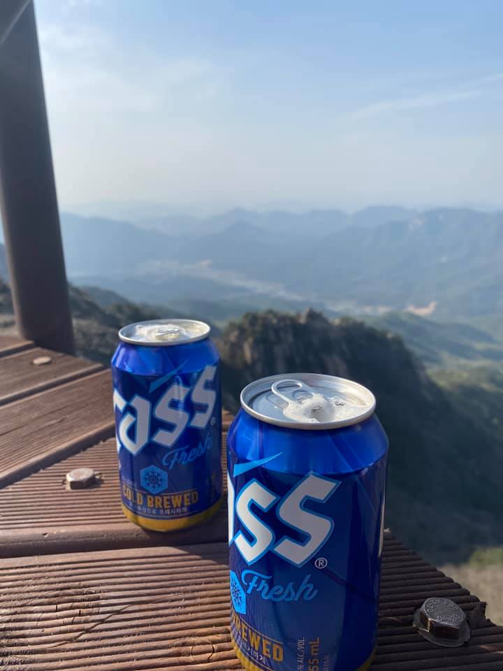 two aluminum cans with the words CASS on them. This is Korean beer, the cans are blue.