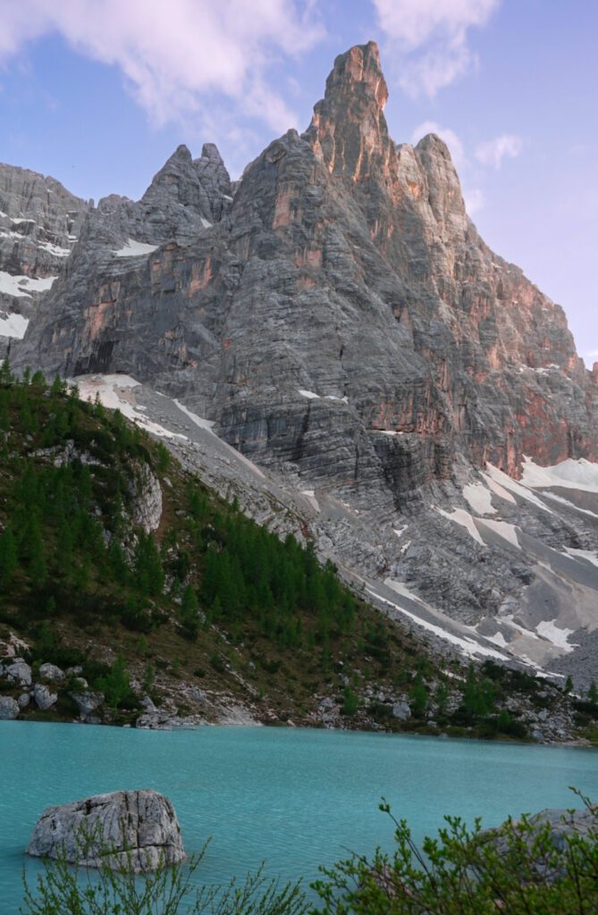 Lago di Sorapis: Stunning blue water set against the jagged peaks of the dolomites at sunset