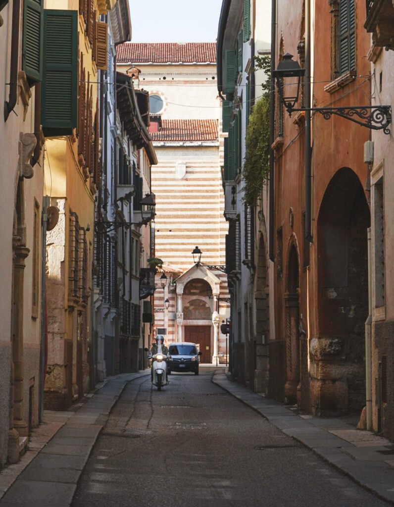 View of the quiet street in Verona with a moped in the background