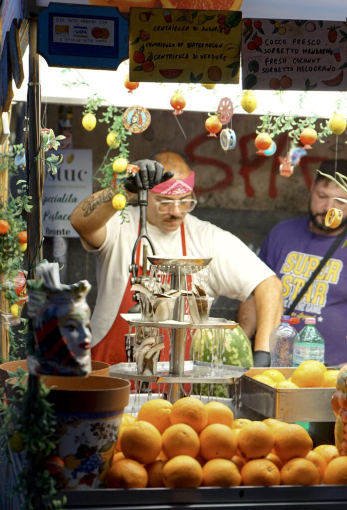 A Man making fresh orange juice on the streets of Catania