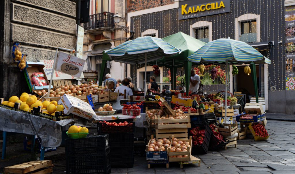 A Vegetable and fruit stand with colorful fruits and veggies in Catania