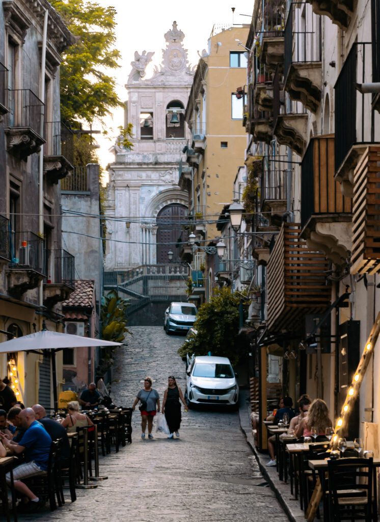 The streets of Catania, with a church in the background