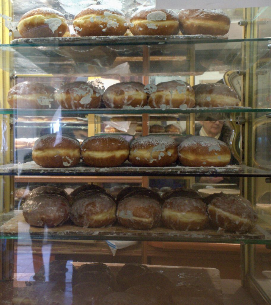 Paczki behind glass at a bakery