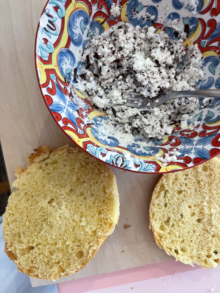 A colorful bowl holds ricotta and dark chocolate in a bowl