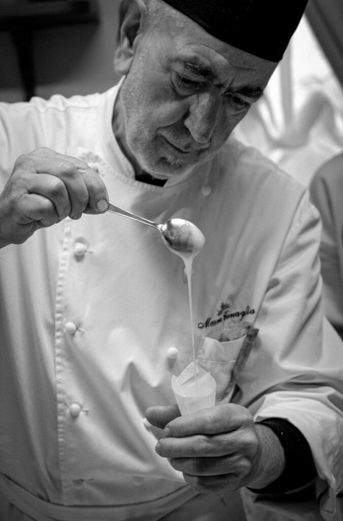 Mauro of Trattoria All'Angelo Pouring sauce in a pippette