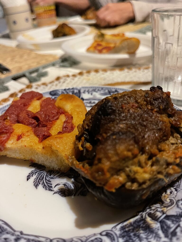 Eggplant and Pizza sitting next to one another