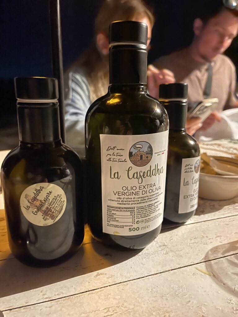Black bottles of Olive oil on a table