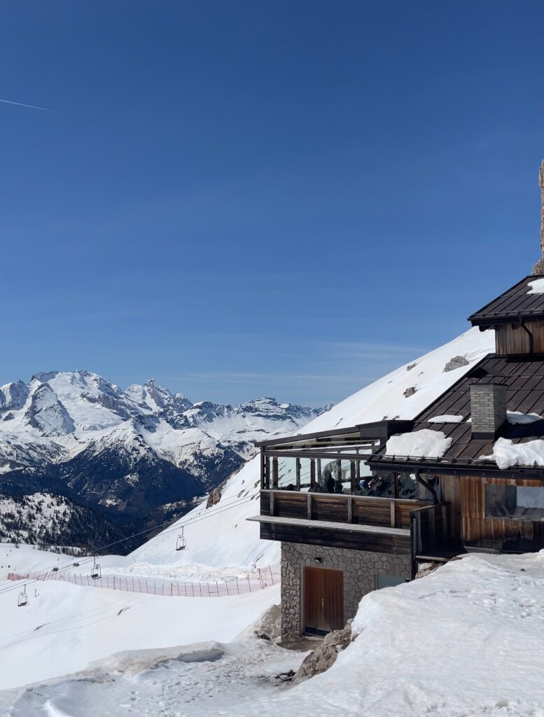 a few of rifugio averau in the snow with mountains in the background
