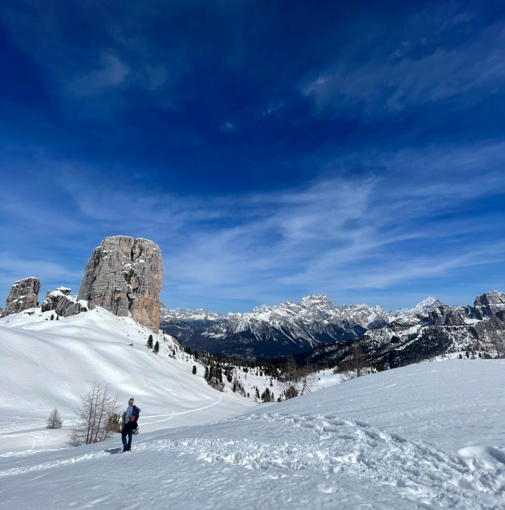 a beautiful snow capped cinque torri and blue skies