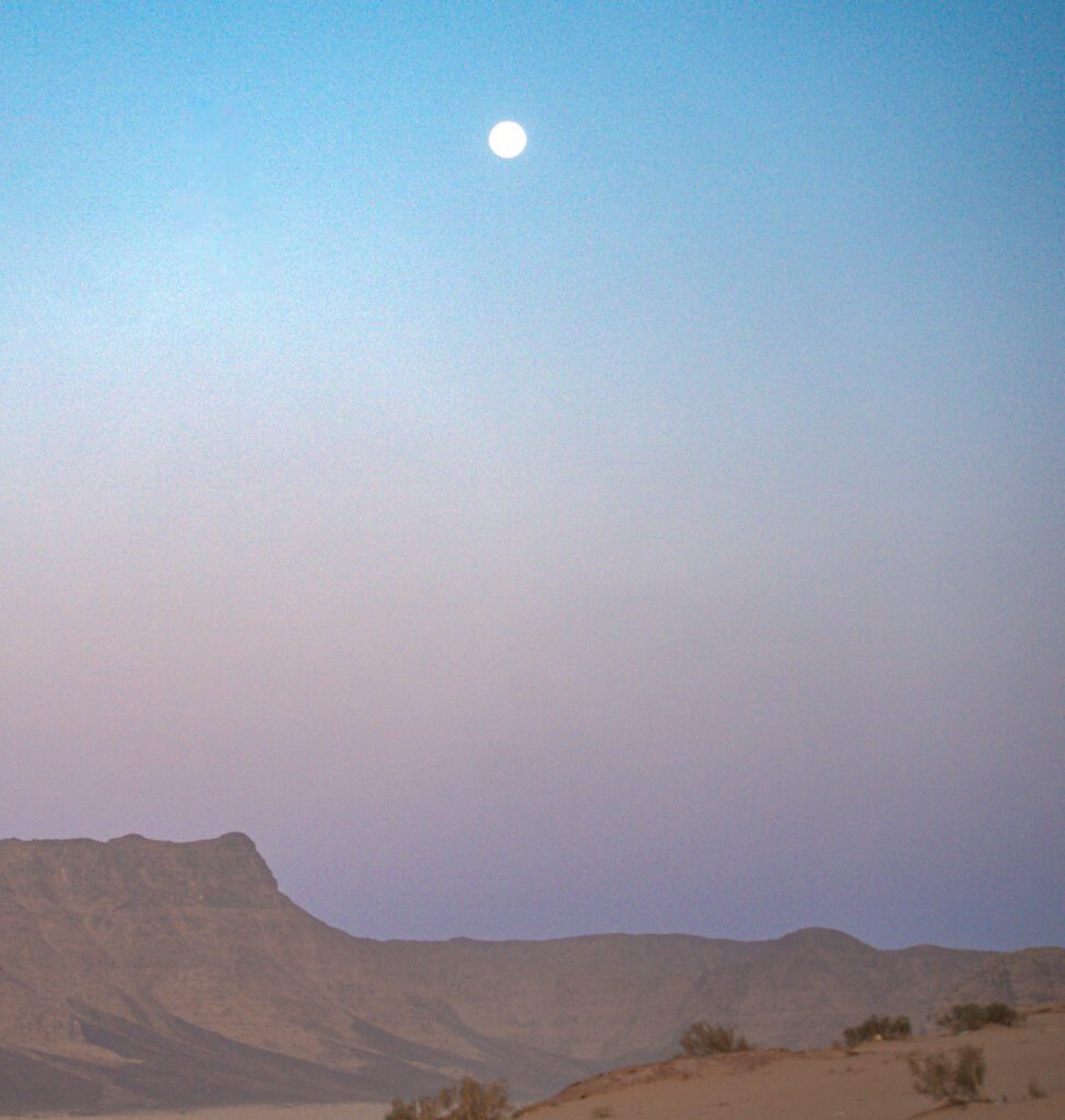 The sunset in Wadi Rum in different colors, blue, purple pink