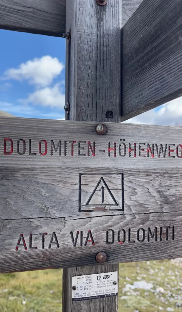 signposting that is made out of wood that says Dolomiten Hohenweg/Alta Via 1 Dolomiti in the Dolomites