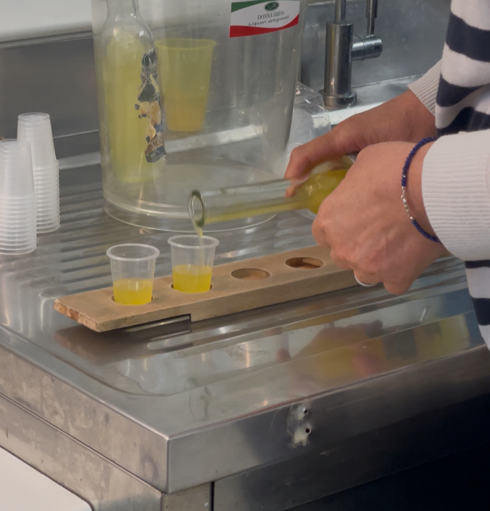 a sample tasting of liqours on a wooden board