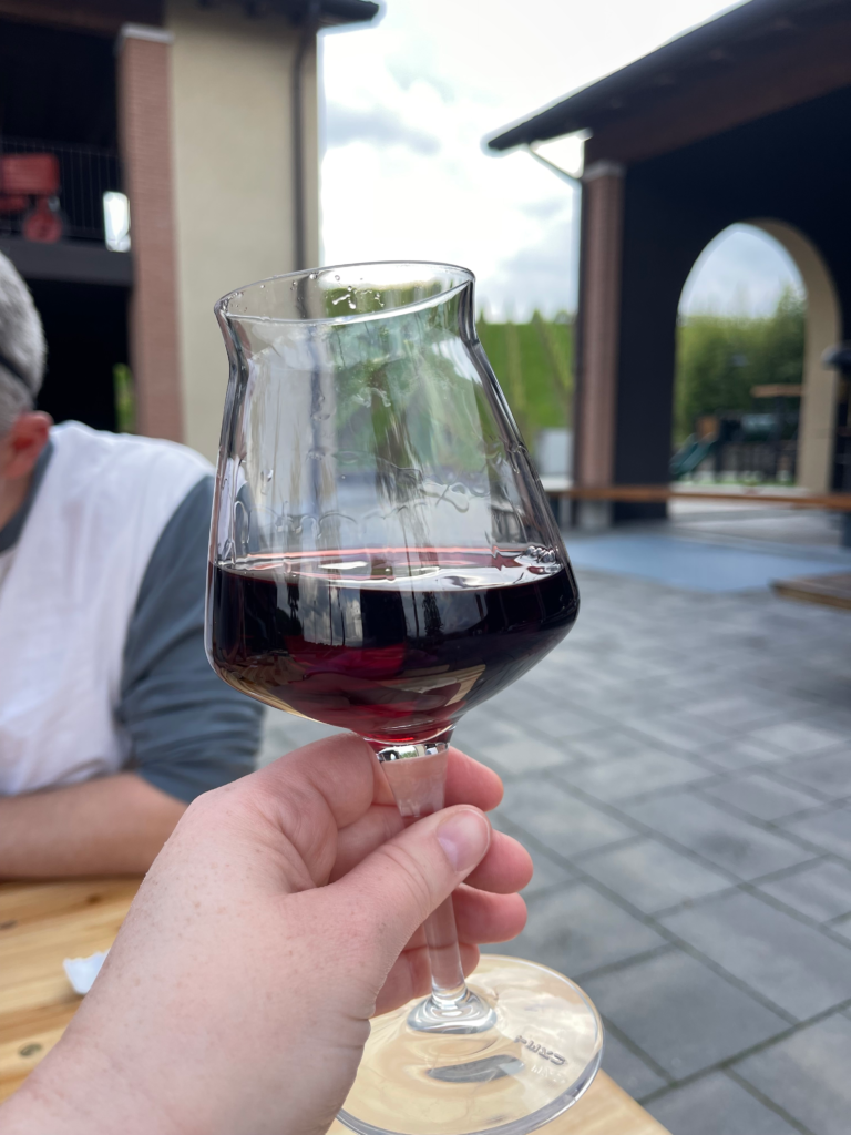 a hand holding a glass of red wine at Luppoland