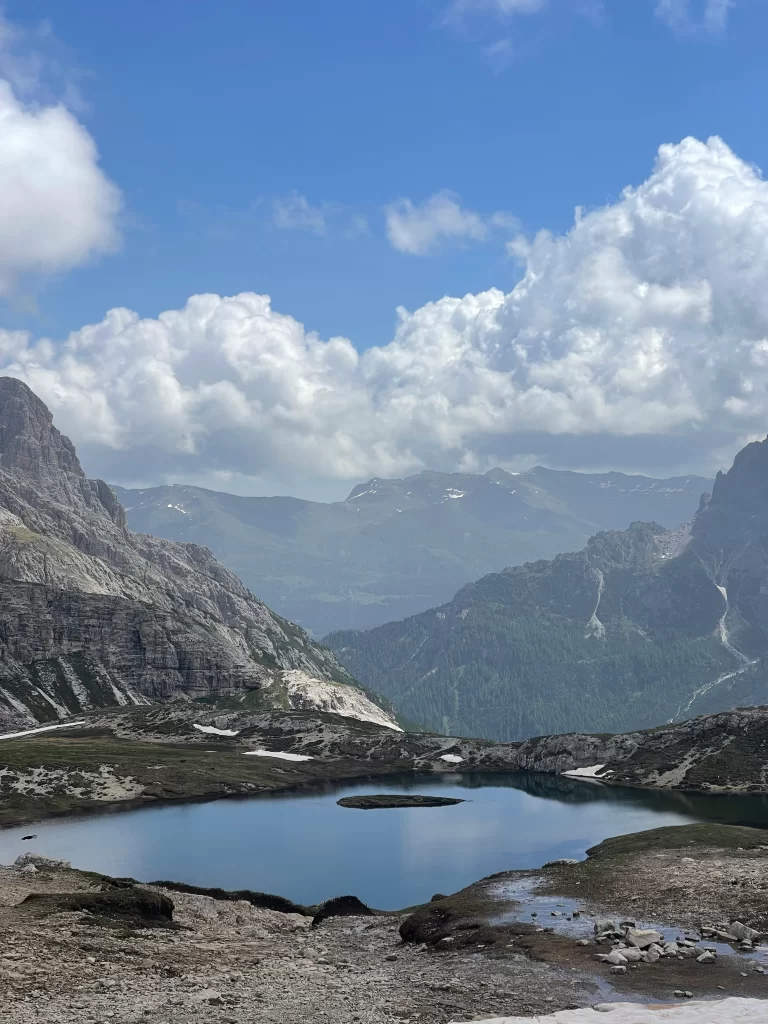 A lake with mountains on the Tre Cime Loop