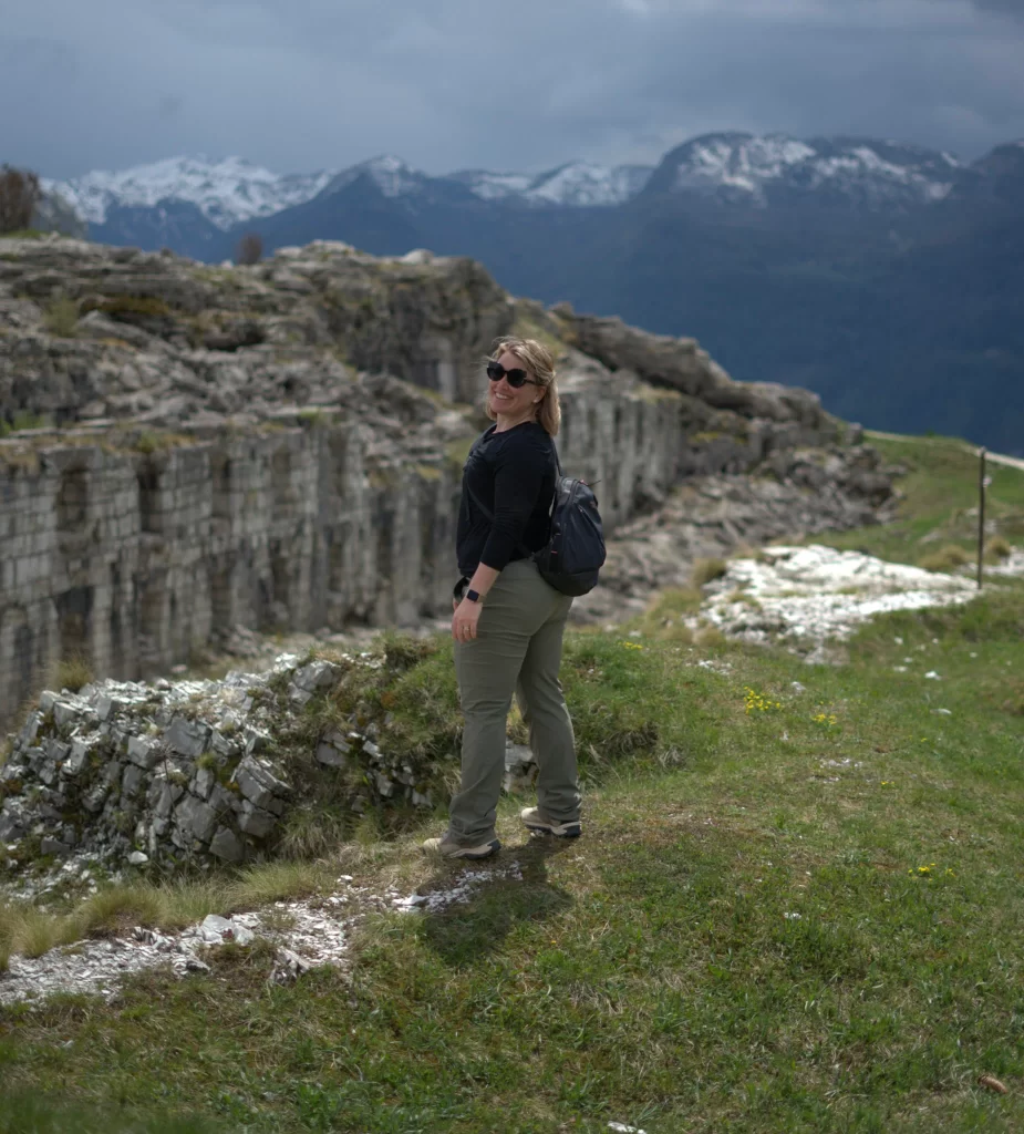 Woman standing in front of a fort in the mountains of Trentino, Italy.