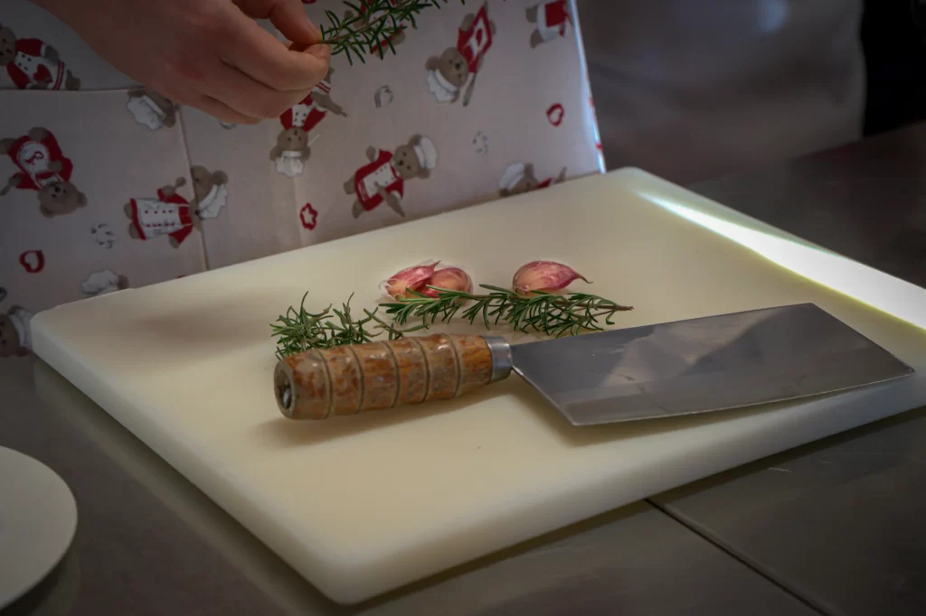 a knife with a shallot on a cutting board at Trattoria All'Angelo