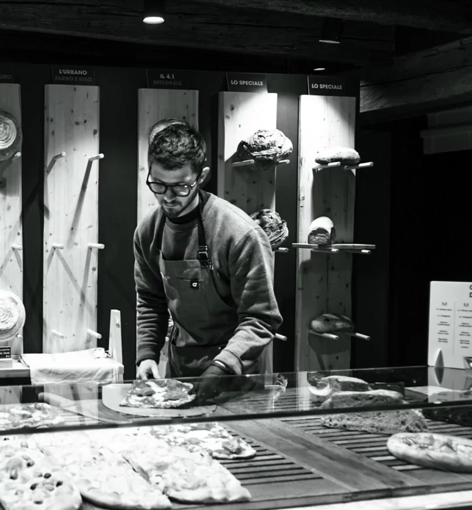 A man serves up some delicious pizza 