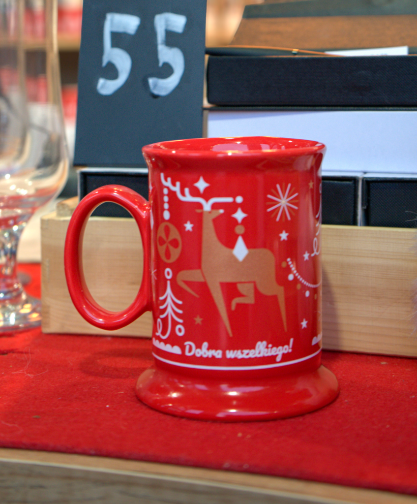 a red christmas market mug with a deer on it