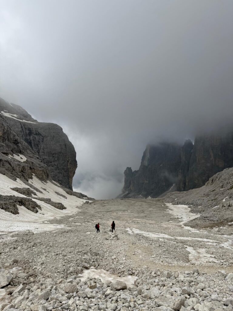 The Pradidali basso filled with scree and towering cliffs on a foggy day in the Dolomites in the Pale Di San Martino