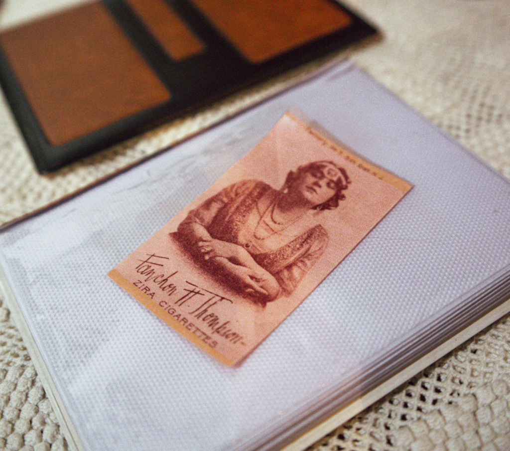 Zira Gold and Copper with bronze detail cigarette silk laying on an album in a women's history museum in Tirana