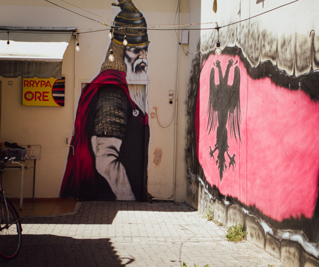 a picture of a viking and an albanian flag on a building the enterance to odas garden in Tirana Albania
