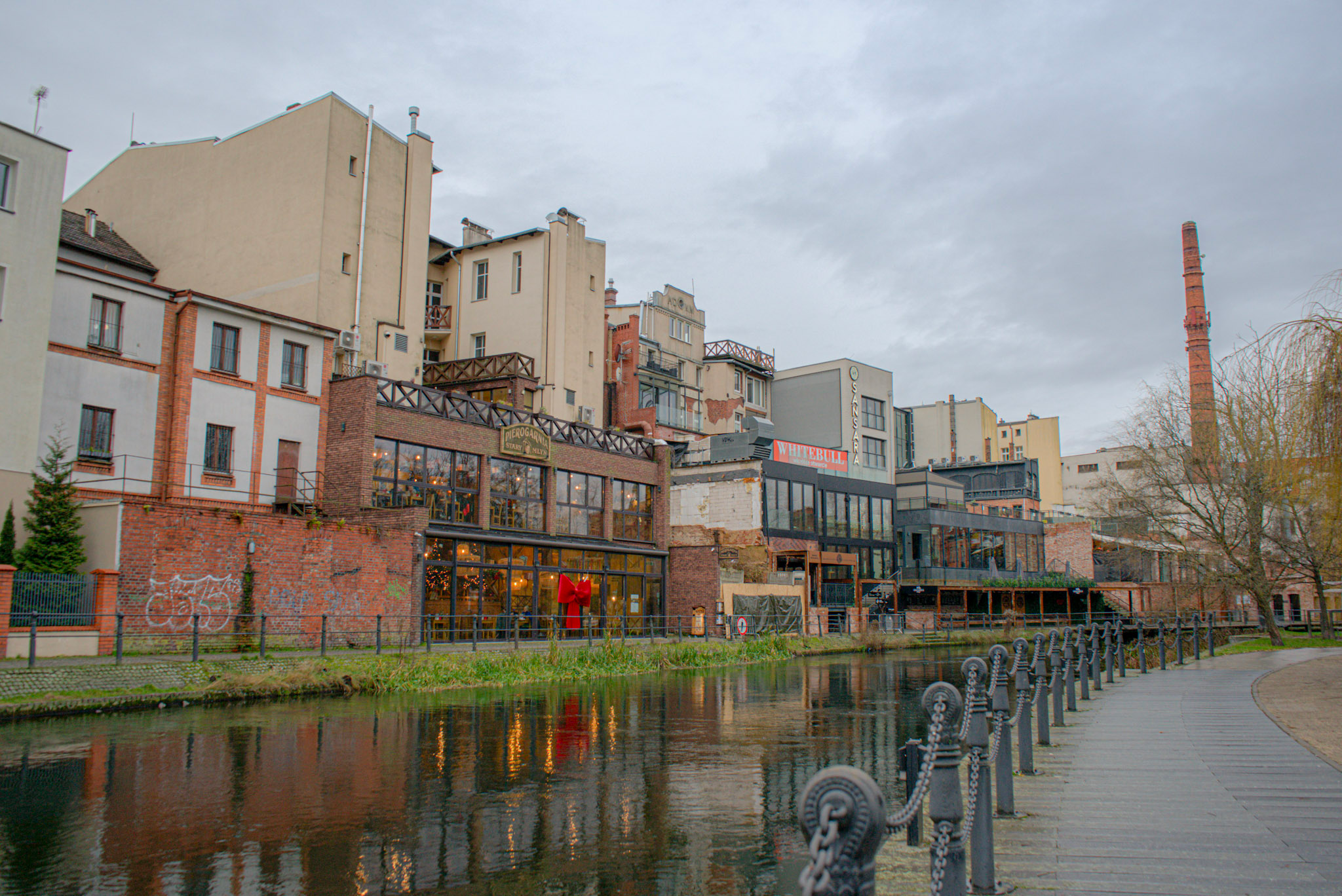 Bydgoszcz, poland riverside with vibrant buildings and grey sky