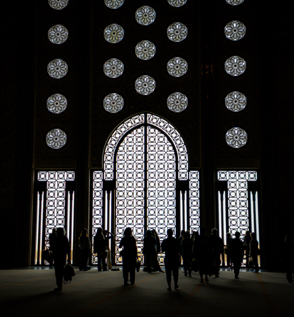 shadows of people up against a window facing the Atlantic Ocean at the Hassan II Mosque