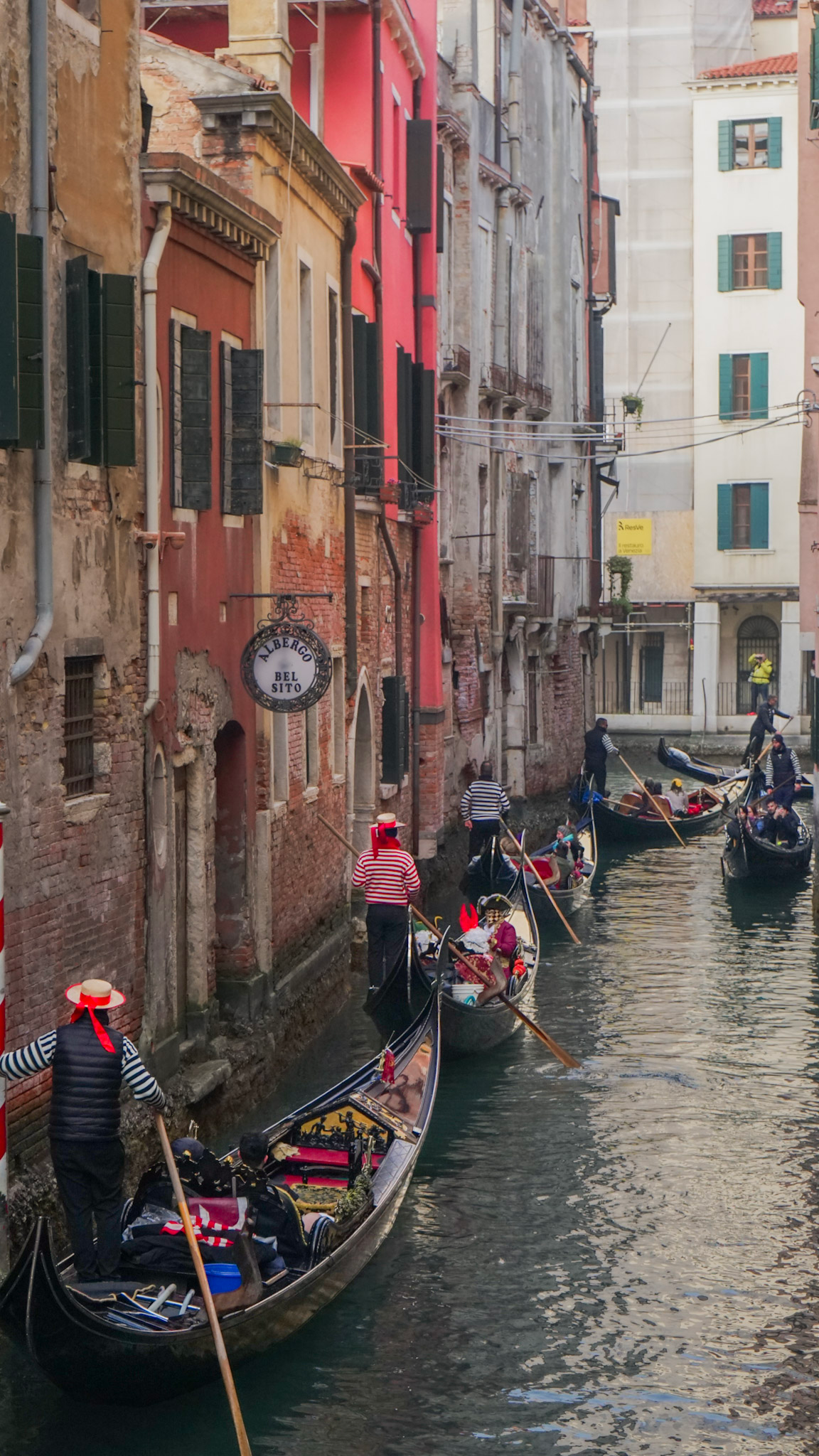 Venetian Gondoliers navigating a traffic jam on a canal in venice