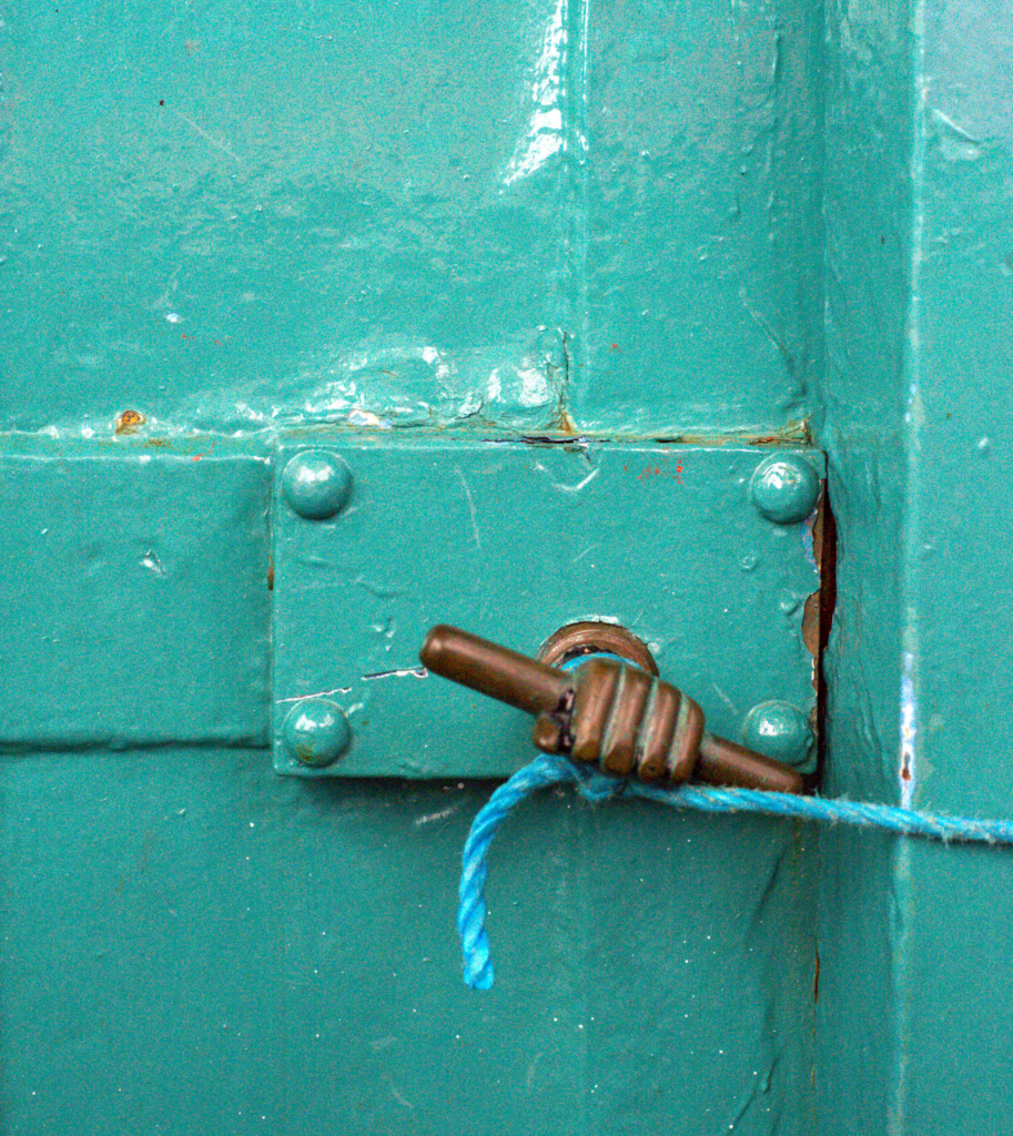 baby blue door with a string tied to the knob that is a hand at the Fanad Lighthouse