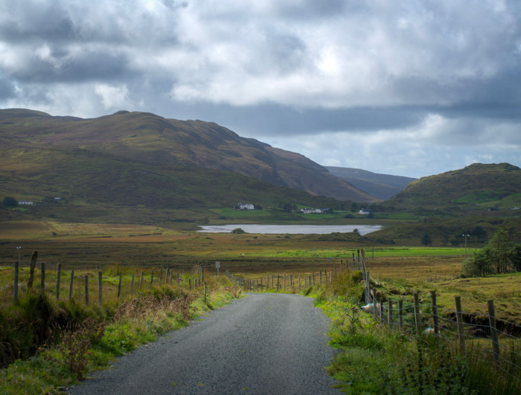 Road to port with mountain views and lush green valleys with a mix of heather